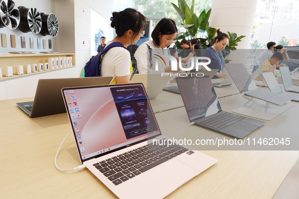 People are experiencing Huawei products at the Huawei store in Wangfujing, Beijing, China, on August 8, 2024. 