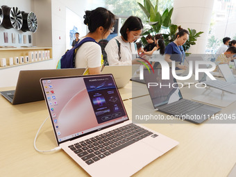 People are experiencing Huawei products at the Huawei store in Wangfujing, Beijing, China, on August 8, 2024. (