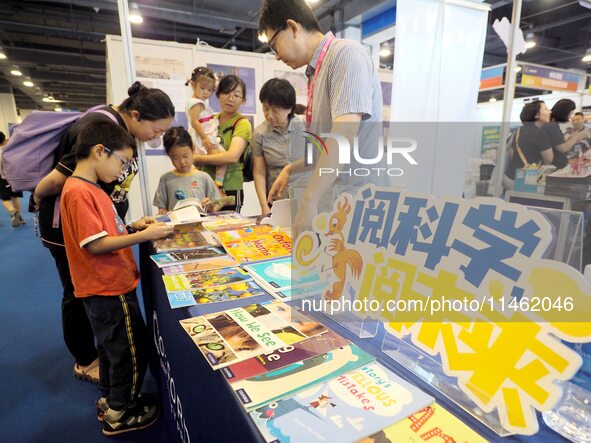 Children are reading science and technology books at the first Beijing International Science Festival 2024 in Beijing, China, on August 8, 2...