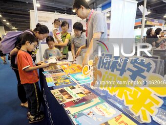 Children are reading science and technology books at the first Beijing International Science Festival 2024 in Beijing, China, on August 8, 2...