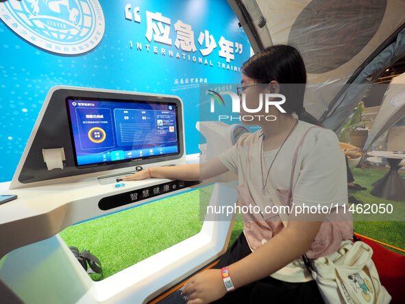 A child is being tested by the ''Smart Health E-station'' at the first Beijing International Science Festival in Beijing, China, on August 8...