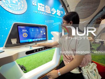 A child is being tested by the ''Smart Health E-station'' at the first Beijing International Science Festival in Beijing, China, on August 8...