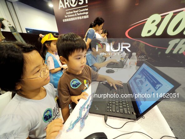 A child is playing a popular science interactive computer game at the first Beijing International Science Festival in Beijing, China, on Aug...