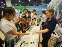 A child is experiencing a ''current conduction experiment'' at the first Beijing International Science Festival in Beijing, China, on August...