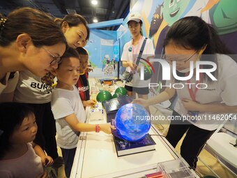 A child is experiencing the ''Earth Magnetic Field Experiment'' at the first Beijing International Science Festival in Beijing, China, on Au...