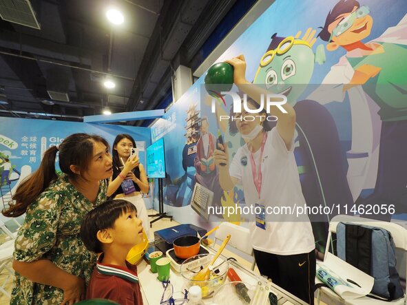 A child is experiencing the ''balloon heating experiment'' at the first Beijing International Science Festival in Beijing, China, on August...