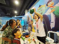 A child is experiencing the ''balloon heating experiment'' at the first Beijing International Science Festival in Beijing, China, on August...