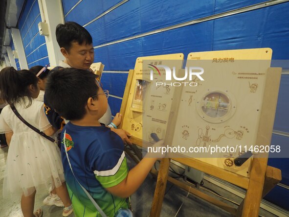 A child is playing a popular science game at the first Beijing International Science Festival in Beijing, China, on August 8, 2024. 