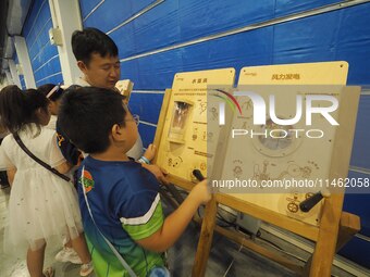 A child is playing a popular science game at the first Beijing International Science Festival in Beijing, China, on August 8, 2024. (