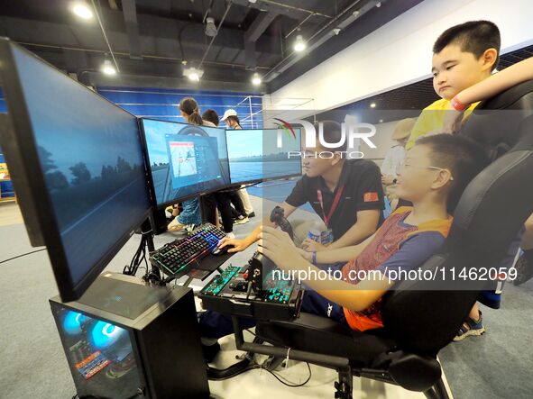 A child is experiencing ''flight simulation with human machine'' at the first Beijing International Science Festival in Beijing, China, on A...