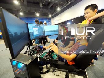 A child is experiencing ''flight simulation with human machine'' at the first Beijing International Science Festival in Beijing, China, on A...