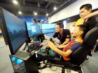 A child is experiencing ''flight simulation with human machine'' at the first Beijing International Science Festival in Beijing, China, on A...