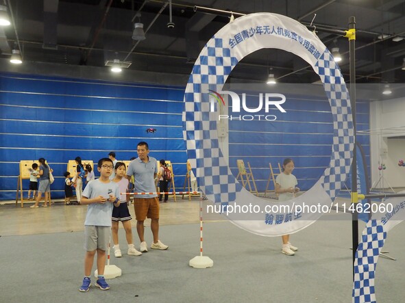 A child is experiencing a ''drone race'' at the first Beijing International Science Festival 2024 in Beijing, China, on August 8, 2024. 