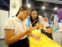 A child is experiencing the ''Energy Ring experiment'' at the first Beijing International Science Festival 2024 in Beijing, China, on August...