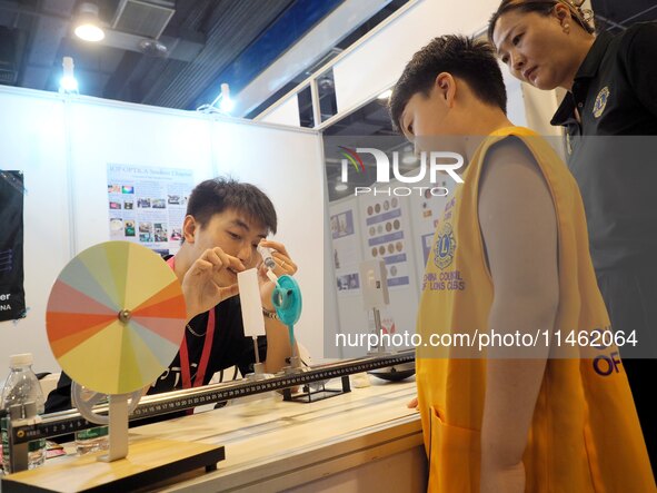 A child is experiencing a lens imaging experiment at the first Beijing International Science Festival 2024 in Beijing, China, on August 8, 2...