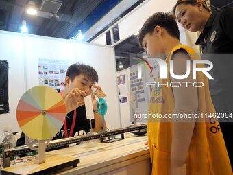 A child is experiencing a lens imaging experiment at the first Beijing International Science Festival 2024 in Beijing, China, on August 8, 2...