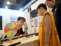 A child is experiencing a lens imaging experiment at the first Beijing International Science Festival 2024 in Beijing, China, on August 8, 2...