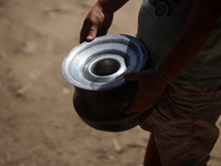 A Palestinian is carrying food cooked by a charity kitchen, amid shortages of aid supplies, as the conflict between Israel and Hamas continu...