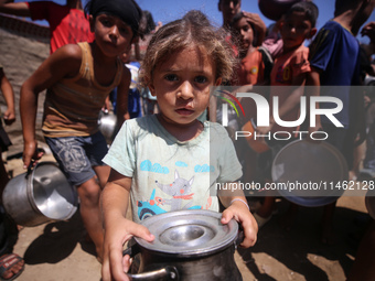 Displaced Palestinians are gathering to receive food cooked by a charity kitchen, amid food scarcity, as the Israel-Hamas conflict continues...