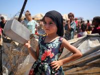 Displaced Palestinians are gathering to receive food cooked by a charity kitchen, amid food scarcity, as the Israel-Hamas conflict continues...