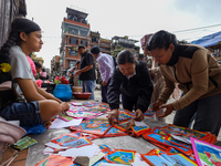 Vendors at a local market near the Patan Durbar Square, a UNESCO World Heritage Site, are selling pictures of the serpent deity ''Naag'' ahe...