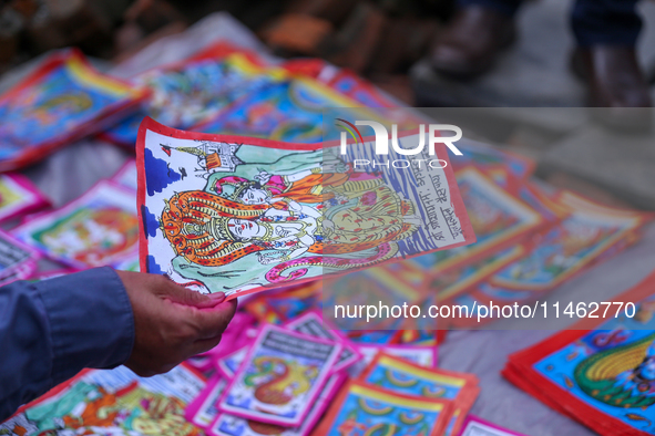 Vendors at a local market near the Patan Durbar Square, a UNESCO World Heritage Site, are selling pictures of the serpent deity ''Naag'' ahe...