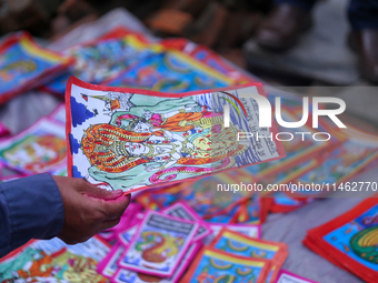 Vendors at a local market near the Patan Durbar Square, a UNESCO World Heritage Site, are selling pictures of the serpent deity ''Naag'' ahe...