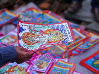 Vendors at a local market near the Patan Durbar Square, a UNESCO World Heritage Site, are selling pictures of the serpent deity ''Naag'' ahe...