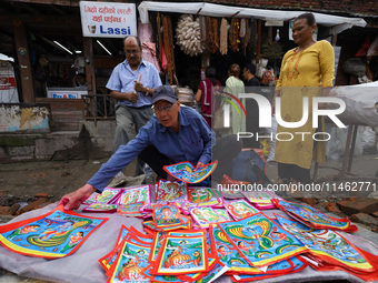 Vendors at a local market near the Patan Durbar Square, a UNESCO World Heritage Site, are selling pictures of the serpent deity ''Naag'' ahe...