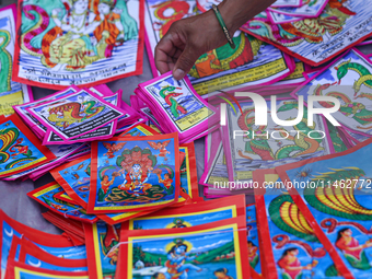 Vendors at a local market near the Patan Durbar Square, a UNESCO World Heritage Site, are selling pictures of the serpent deity ''Naag'' ahe...