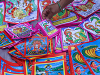 Vendors at a local market near the Patan Durbar Square, a UNESCO World Heritage Site, are selling pictures of the serpent deity ''Naag'' ahe...