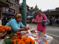 Vendors at a local market near the Patan Durbar Square, a UNESCO World Heritage Site, are selling pictures of the serpent deity ''Naag'' ahe...