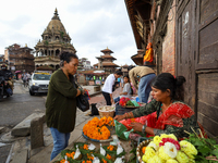 Vendors at a local market near the Patan Durbar Square, a UNESCO World Heritage Site, are selling pictures of the serpent deity ''Naag'' ahe...