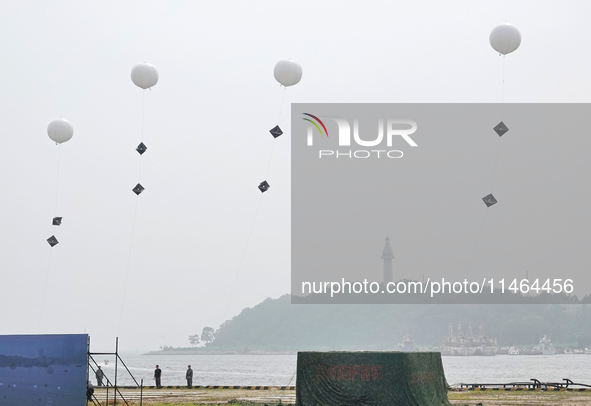 A national defense mobilization professional support team is releasing a floating balloon with an Angle reflector during a comprehensive def...