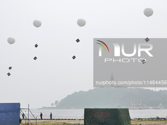 A national defense mobilization professional support team is releasing a floating balloon with an Angle reflector during a comprehensive def...