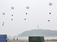 A national defense mobilization professional support team is releasing a floating balloon with an Angle reflector during a comprehensive def...