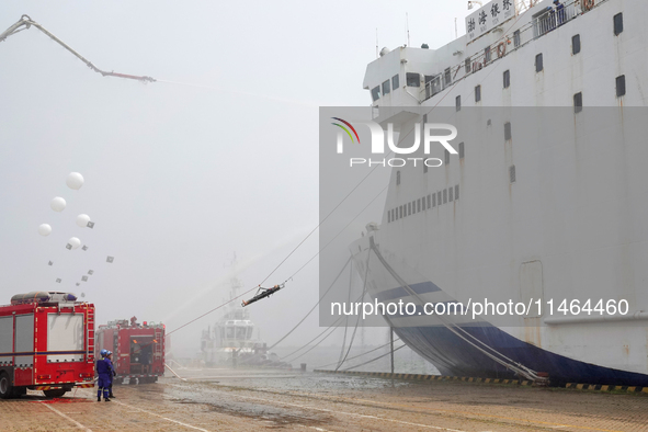 Rescuers are transferring injured people off a ship during a comprehensive defense mobilization exercise in Yantai, China, on August 9, 2024...