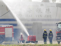 A fire-fighting robot is performing fire-fighting operations during a comprehensive defense mobilization drill in Yantai, China, on August 9...