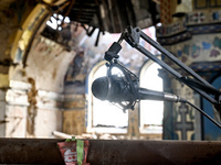 A microphone is at the Church of the Nativity of the Blessed Virgin Mary, damaged by the Russian shelling on July 8, in Novoekonomichne, Don...