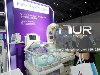 Visitors are visiting a ''multi-functional baby incubator'' at the 30th China International Medical Instruments and Equipment Exhibition in...