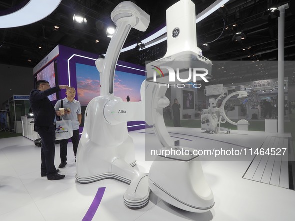 Visitors are visiting a ''high-end composite operating room robot'' at the 30th China International Medical Instruments and Equipment Exhibi...