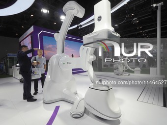 Visitors are visiting a ''high-end composite operating room robot'' at the 30th China International Medical Instruments and Equipment Exhibi...