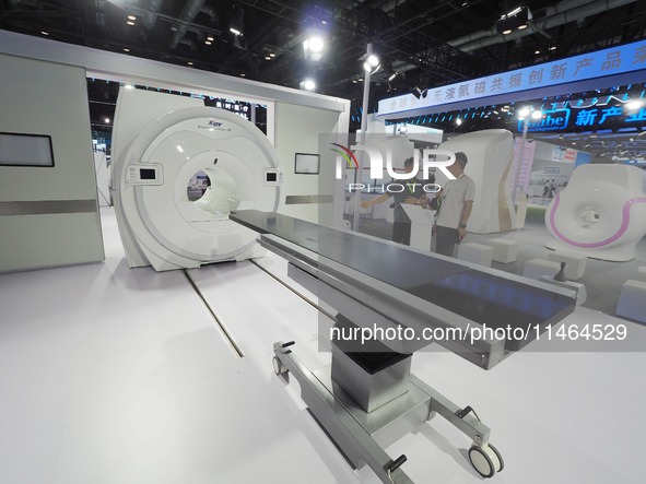 Visitors are visiting the ''Liquid helium-free superconducting magnetic resonance for Compound Operating Room'' equipment at the 30th China...