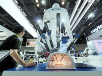 Visitors are experiencing ''minimally invasive robots'' at the 30th China International Medical Instruments and Equipment Exhibition in Beij...