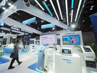 Visitors are viewing laser therapy equipment at the 30th China International Medical Instruments and Equipment Exhibition in Beijing, China,...