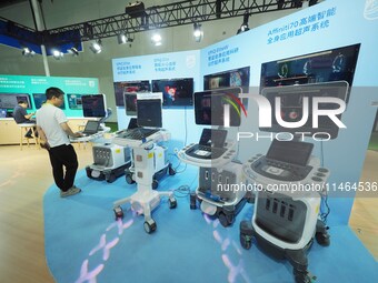 Visitors are visiting ultrasound system equipment at the 30th China International Medical Instruments and Equipment Exhibition in Beijing, C...