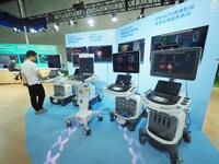 Visitors are visiting ultrasound system equipment at the 30th China International Medical Instruments and Equipment Exhibition in Beijing, C...