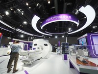 Visitors are viewing the ''Ophthalmic surgical microscope'' at the 30th China International Medical Instruments and Equipment Exhibition in...