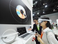 Visitors are experiencing the ''Eye Disease Screening System'' at the 30th China International Medical Instruments and Equipment Exhibition...