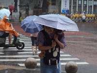 Pedestrians are walking during a rainstorm in Beijing, China, on August 9, 2024. (